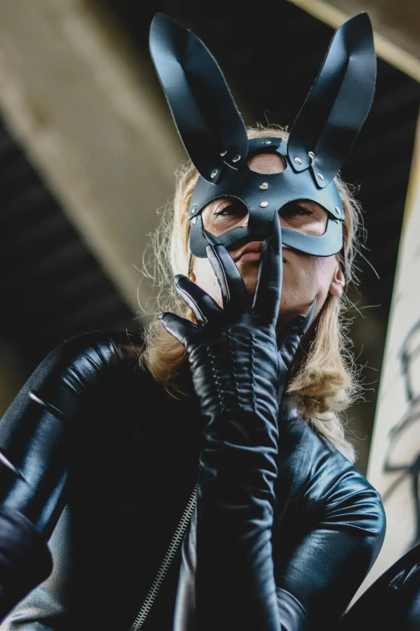 Person in black latex bunny costume