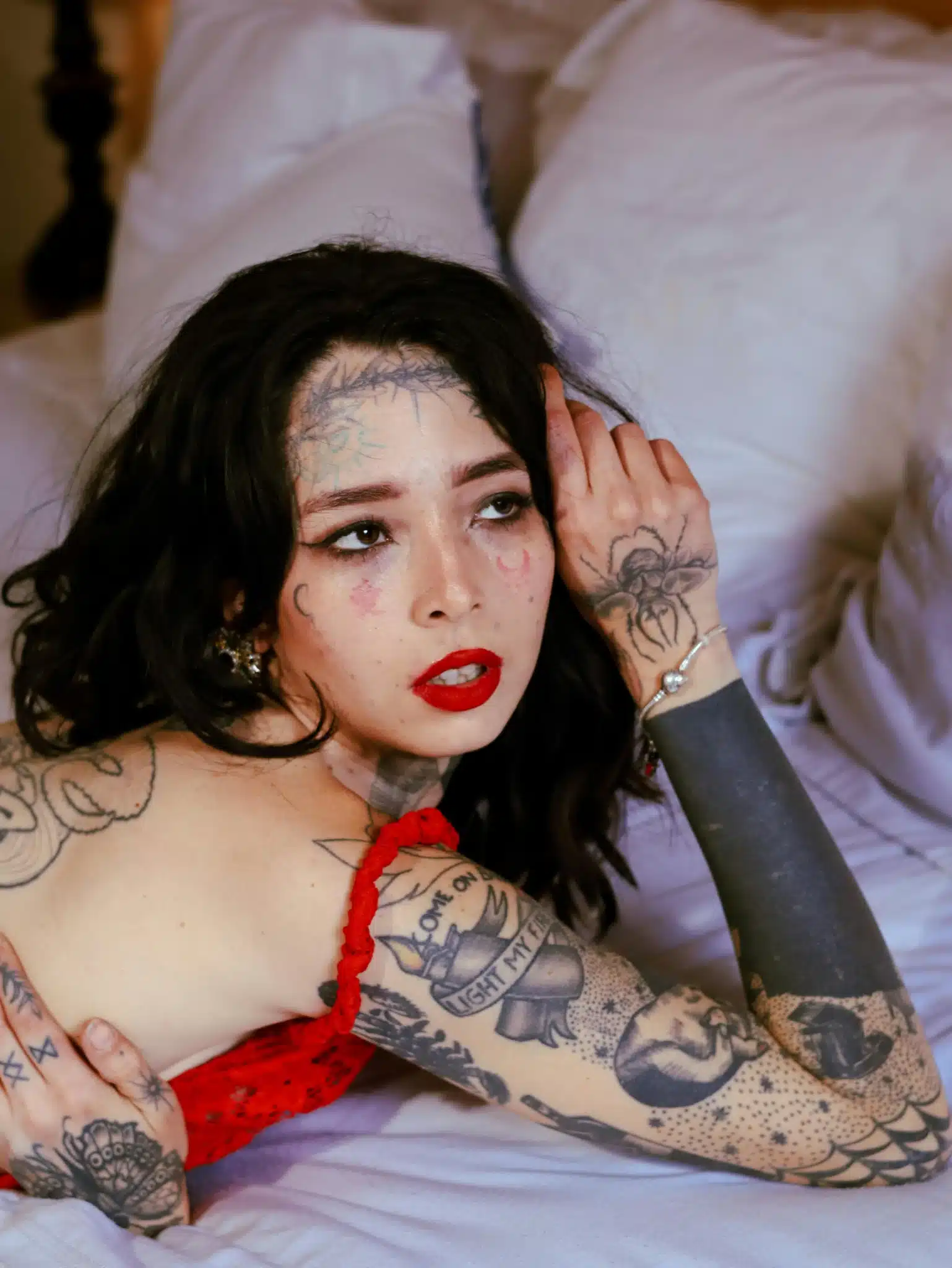 Tattooed person in red attire