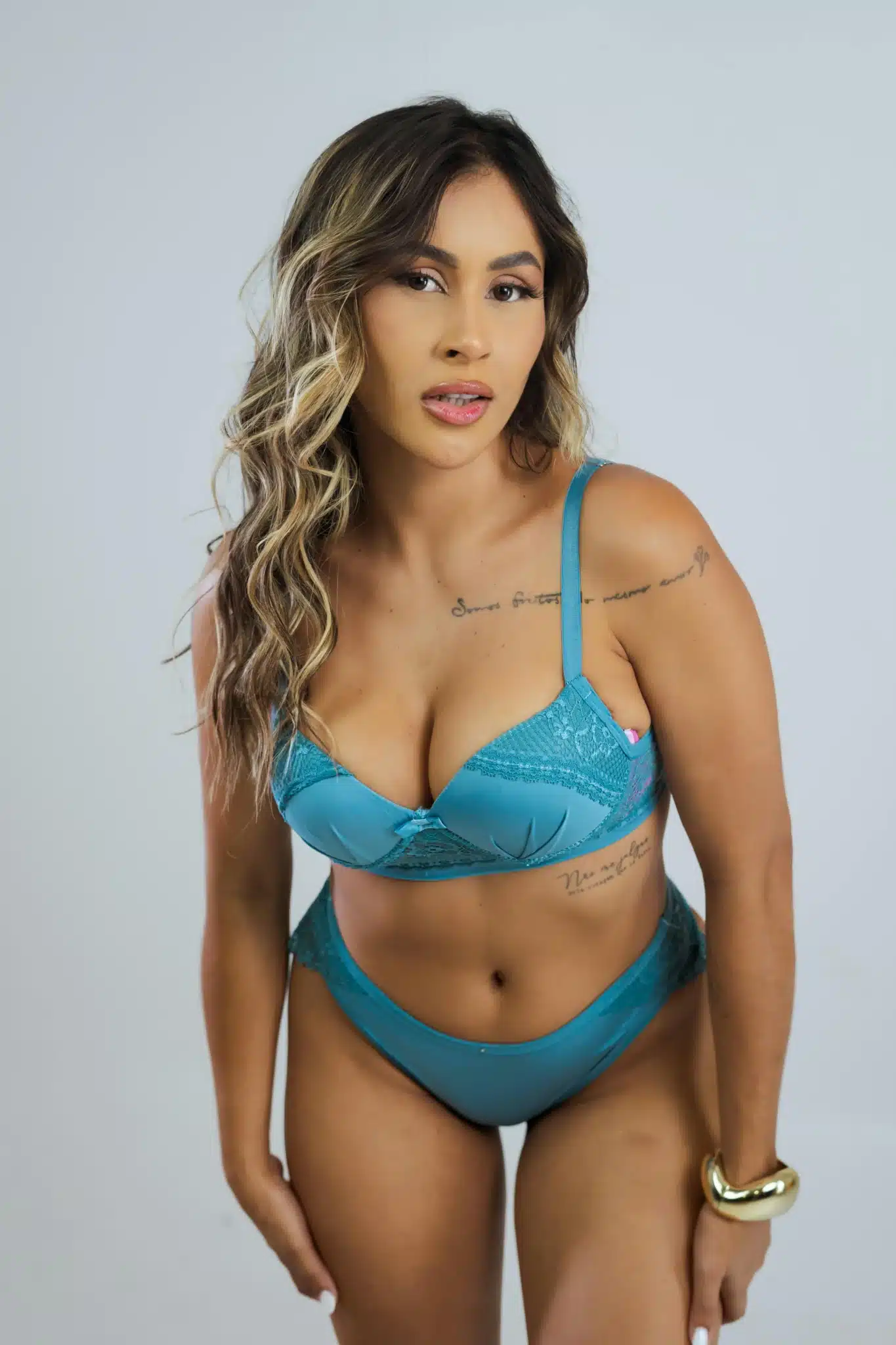 Woman in teal bikini posing confidently