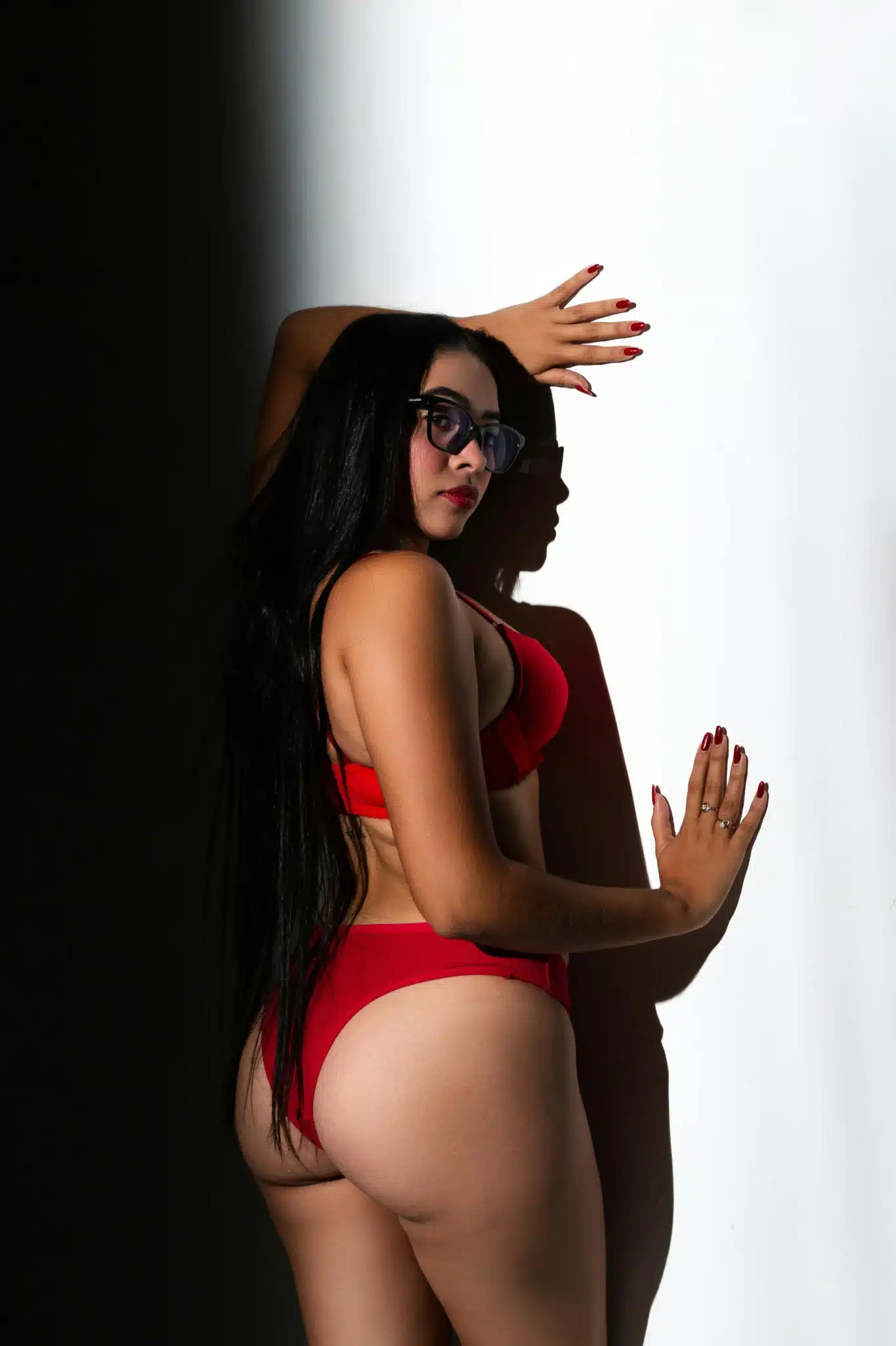 Woman in red lingerie posing