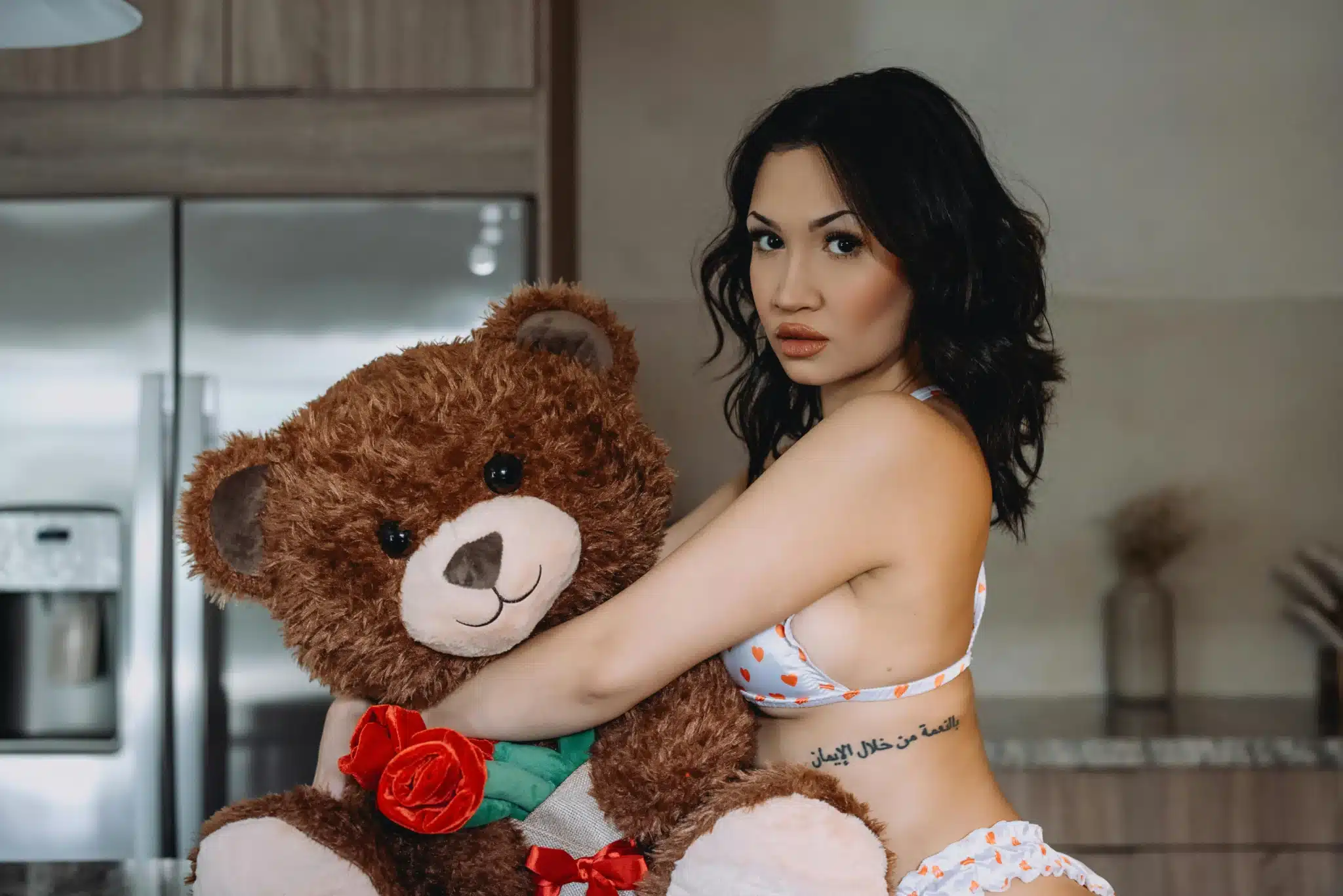 Woman holding large teddy bear